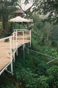 a wooden deck with an umbrella on top of it at Retro Khe Sanh in Lao Bao