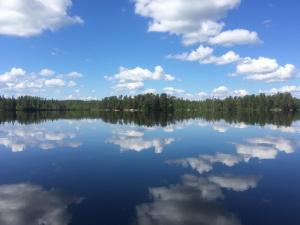 a view of a lake with clouds in the water at Jurtta Linkkumylly in Mäntyharju