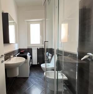 a bathroom with a sink and a toilet and a shower at Davide Rome Apartment in Rome