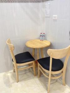 einen Tisch und zwei Stühle sowie einen Tisch und einen Tisch in der Unterkunft Nhà nghỉ Ngọc Duy Bến Tre in Ben Tre