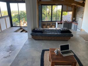 a bedroom with two beds and a laptop on a table at Villa Calme et Vue au RDV/Piscine/Plage 10 min in Étang-Salé