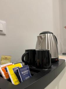 a counter top with two coffee cups and a toaster at Maqueda Suites in Palermo