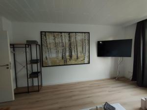 a living room with a flat screen tv on a wall at Ferienwohnung in der Sanderau in Würzburg
