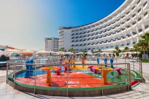 a water park in front of a large building at Calido Maris Hotel Ultra All Inclusive in Kızılot