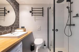 a bathroom with a shower and a sink and a toilet at Hilltop Apartments - Ilmarine district in Tallinn