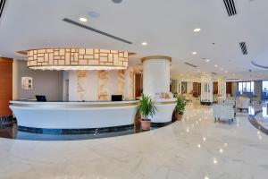 a lobby of a hotel with a reception desk at Calido Maris Hotel Ultra All Inclusive in Kızılot