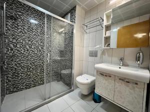 a bathroom with a shower and a toilet and a sink at MANDALİN AKYAKA in Akyaka +130 photos