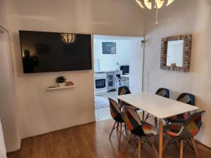 a dining room with a table and chairs and a television at Apartment Dolores in Cres