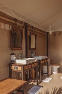 a bathroom with two sinks and a toilet at Aladdin Luxury Camp Phuket in Phuket Town