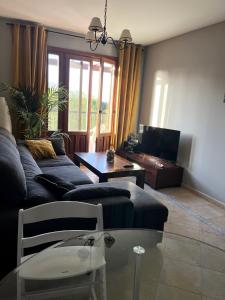 a living room with a couch and a table at Ayamonte - Vista Esuri Golf and Beach in Huelva