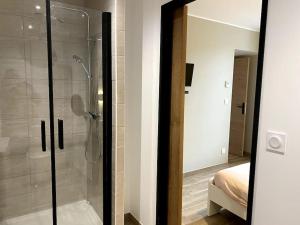 a bathroom with a shower with a glass door at Gite du Pavillon in Rocroi