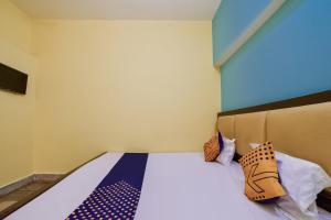 a bedroom with a bed with ties on it at SPOT ON Luv-kush Inn in Bankipur