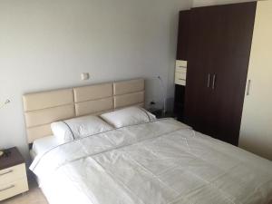 a bedroom with a large bed with white sheets at Bella Vera Apartments 2 in Limenas