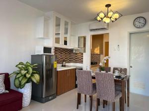 a kitchen and dining room with a table and a refrigerator at Homestay 10mins drive to Alona Beach , Panglao Island in Dauis