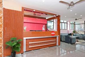 a lobby with a restaurant with a red counter at Capital O Hotel Aryan in Khandagiri
