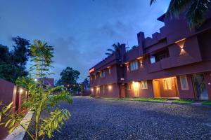 an exterior view of a building at night at Flagship South Fort Inn in Alleppey