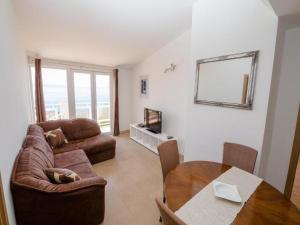 a living room with a couch and a table at Apartments Bandalo in Podstrana +19 photos