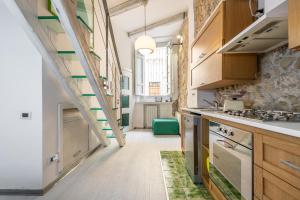 a kitchen with wooden cabinets and a staircase at Casa S'anna in Cagliari