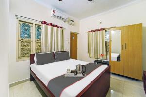a bedroom with a large bed in a room at Collection O Arn Guest House Near Chennai International Airport in Chennai