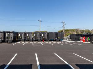 an empty parking lot with a bunch of containers at HOTEL R9 The Yard Koge in Nakatsu