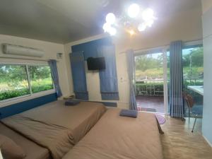 Postel nebo postele na pokoji v ubytování Rayonghouse Resort