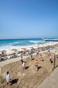 a group of people playing volley ball on the beach at Saphir Hotel & Villas in Konaklı