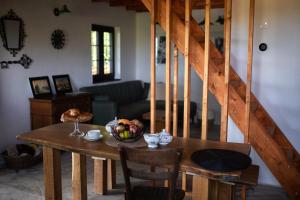 a table with a bowl of fruit on it in a living room at Libling Hruštička in Banská Štiavnica