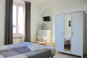 a bedroom with a bed and a large mirror at Le Residenze Della Poetessa in Corsico