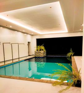 a large swimming pool in a large room with a large screen at Via Appia Tagaytay in Tagaytay