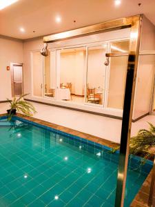 a swimming pool in a house with a mirror at Via Appia Tagaytay in Tagaytay