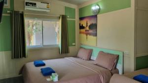 Postel nebo postele na pokoji v ubytování Rayonghouse Resort