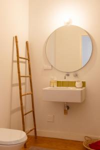 a bathroom with a sink and a mirror at Casa do Almirante in Tavira