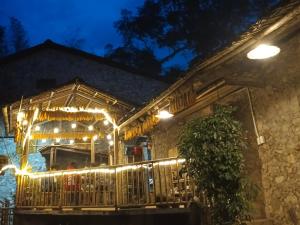 a house with lights on a porch at night at Quang Thuận Bản Giốc Homestay in Cao Bằng