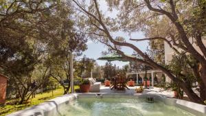 a pool in the middle of a yard with trees at Casa Valentina 6 Emma Villas in Porto Istana