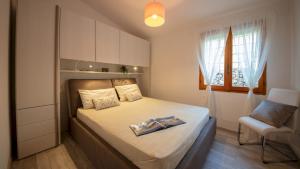 a small bedroom with a bed and a chair at Casa Valentina 6 Emma Villas in Porto Istana