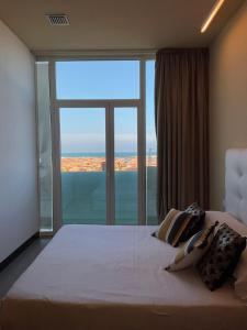 a bedroom with a large bed with a large window at Residence Terminus in Rimini