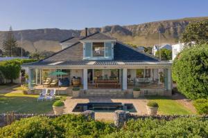 an aerial view of a house with a pool at Wild Waters at Kraal Rock on the cliffs in Hermanus in Hermanus