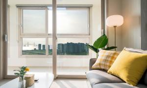 a living room with a couch and a large window at Urbanstay Songdo Moonlight Park in Incheon