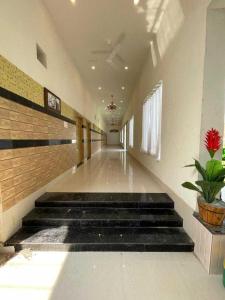 a hallway of a school with stairs and a plant at OYO Vaikunth Radhika Farm in Govardhan
