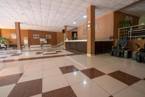 a lobby of an airport with a check in counter at Rohat Hotel Chilonzor in Tashkent