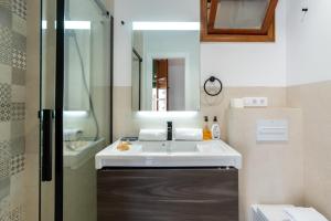 a bathroom with a white sink and a mirror at La Casa (Casa familiar Premium) in Seville