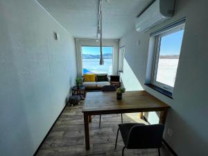 a living room with a table and a view of the ocean at FLEXWORK tawa in Shibecha