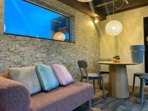a living room with a couch and a table at FLEXWORK tawa in Shibecha