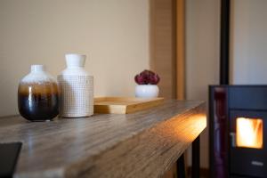 a counter with two vases sitting on top of it at VIVI TIRANO[300m dal treno rosso del Bernina] in Tirano