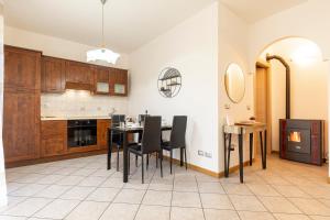 a kitchen with a table and chairs in a room at VIVI TIRANO[300m dal treno rosso del Bernina] in Tirano