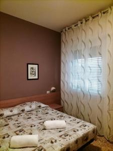 a bedroom with a bed and a window at Il Centrale in Cortona