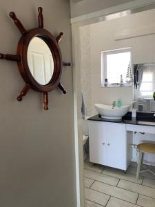 a bathroom with a sink and a mirror on the wall at Uvongo Chalet 11 in Margate