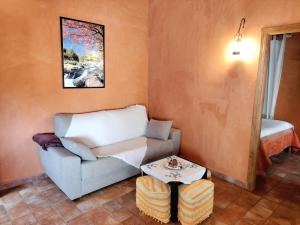a living room with a couch and a table at Apartamentos El Mirador in Candeleda