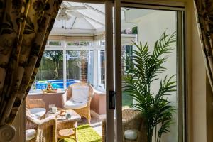 an open door to a patio with a table and chairs at Chichester retreat house with free parking in Chichester