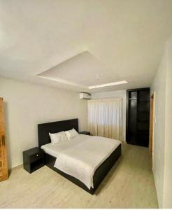 a bedroom with a large bed in a room at The GA Apartment in Abeokuta